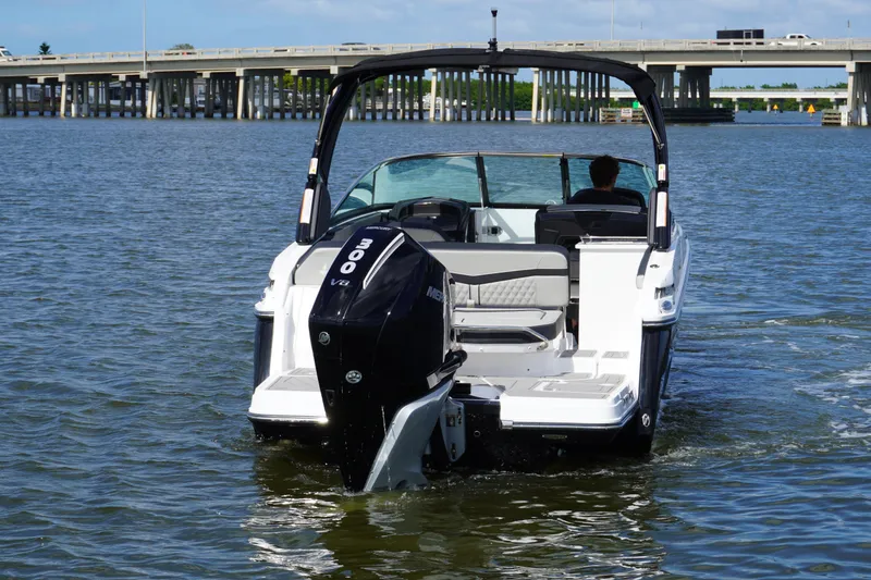 Slide: The Image of 2026 Monterey 255SS Super Sport boat cruising on a lake near a bridge. - 6