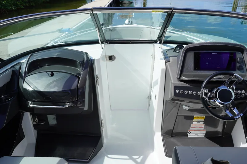 Slide: The Image of 2026 Monterey 255SS Super Sport boat cockpit with modern steering and dashboard controls. - 30