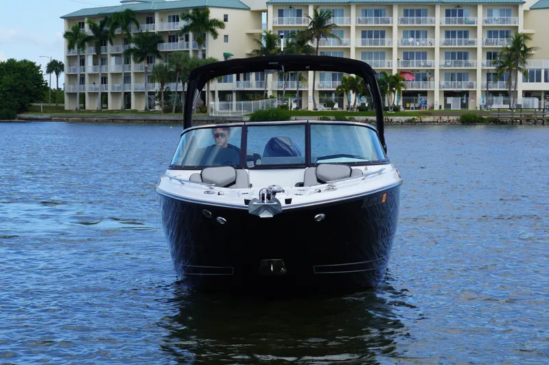 Slide: The Image of 2026 Monterey 255SS Super Sport boat on water near waterfront buildings. - 2