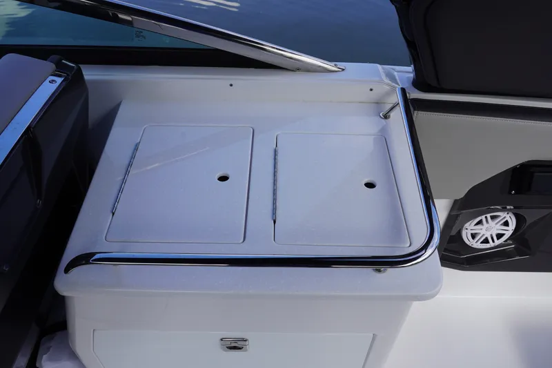 Slide: The Image of 2026 Monterey 255SS Super Sport boat interior with storage compartment and speaker. - 19