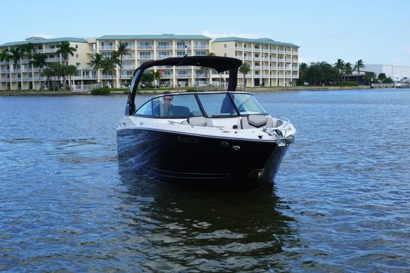 Slide: The Image of 2026 Monterey 255SS Super Sport boat on water near waterfront buildings. - 1
