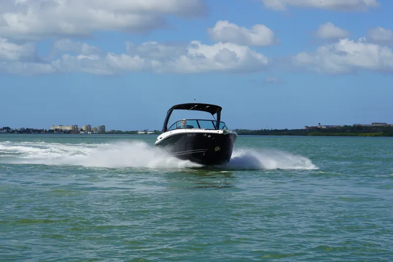 Slide: The Image of 2026 Monterey 255SS Super Sport boat cruising on open water under a blue sky. - 37