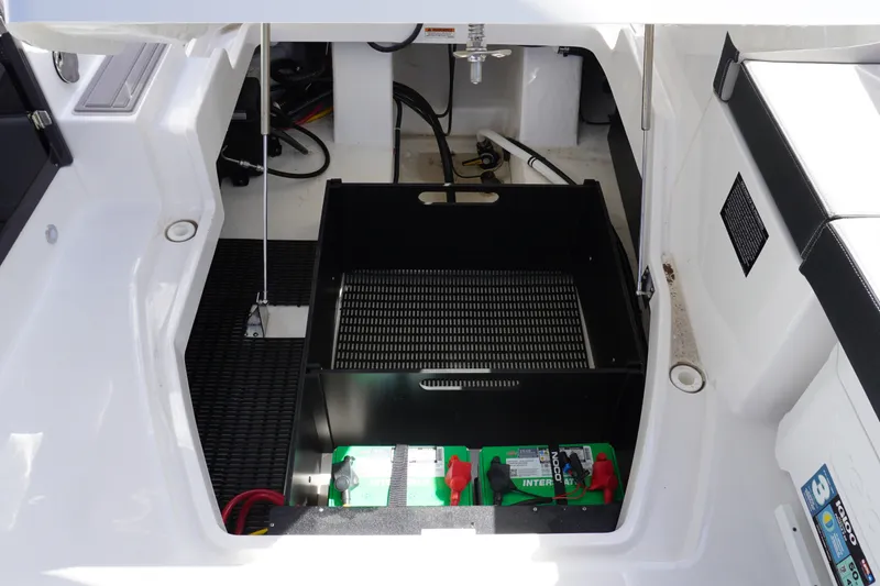 Slide: The Image of 2026 Monterey 255SS Super Sport boat battery compartment with storage space. - 16