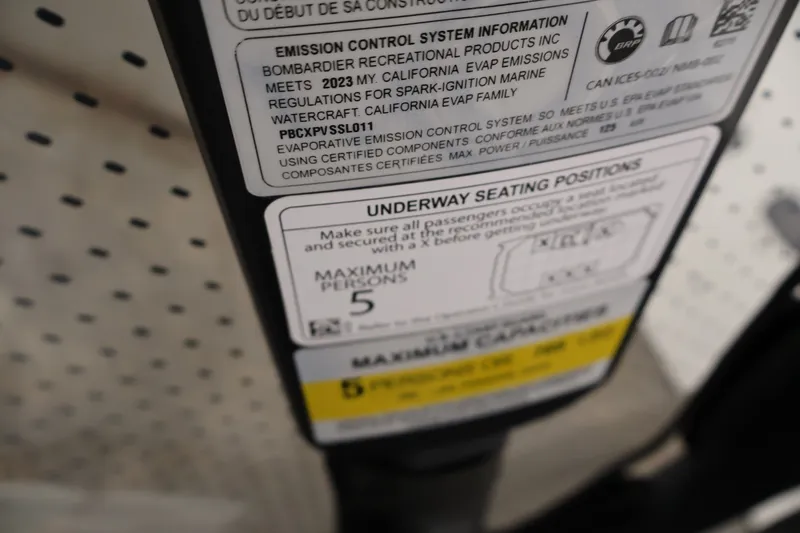 Slide: The Image of Label on 2023 Sea-Doo Switch Sport Compact detailing emission control and seating capacity. - 34