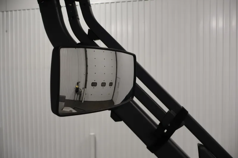 Slide: The Image of Side mirror of 2023 Sea-Doo Switch Sport Compact reflecting a garage door. - 23