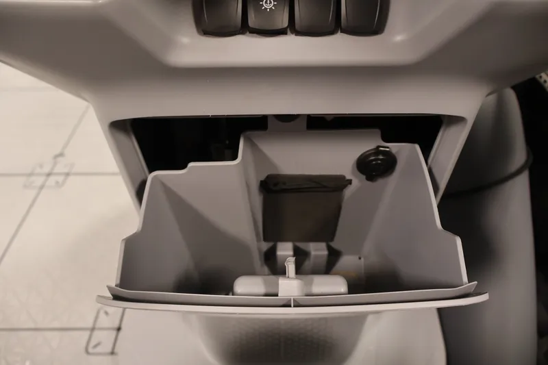 Slide: The Image of 2023 Sea-Doo Switch Sport Compact storage compartment with control buttons. - 22