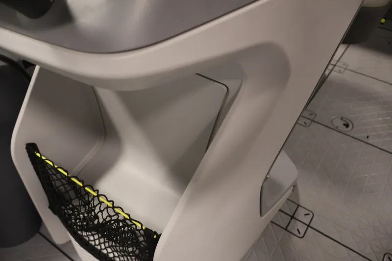 Slide: The Image of 2023 Sea-Doo Switch Sport Compact interior storage with netting on textured floor. - 14