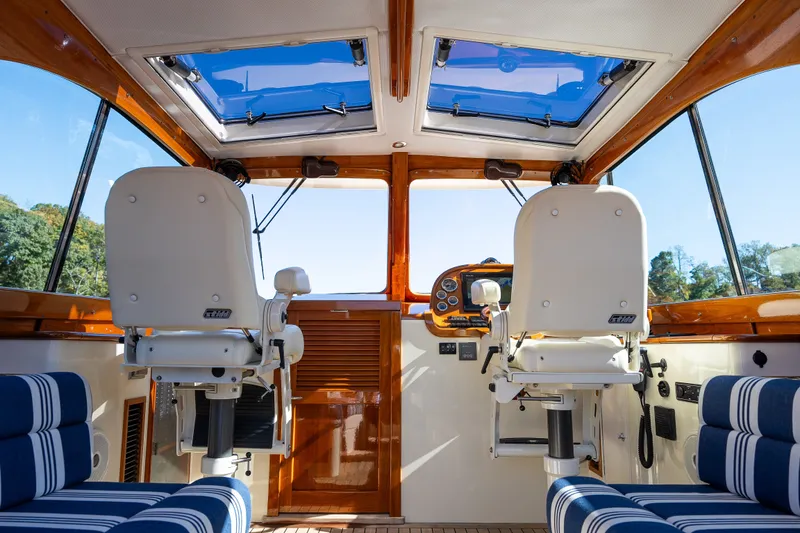 Slide: The Image of Interior of 2017 Hinckley Picnic Boat 37 MKIII with helm seats and panoramic windows. - 22