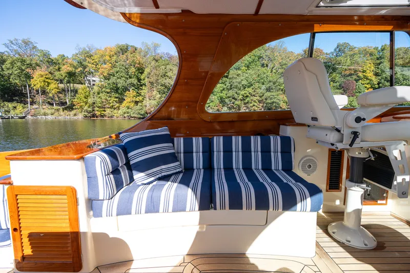 Slide: The Image of Interior of 2017 Hinckley Picnic Boat 37 MKIII with striped seating and wooden accents. - 20