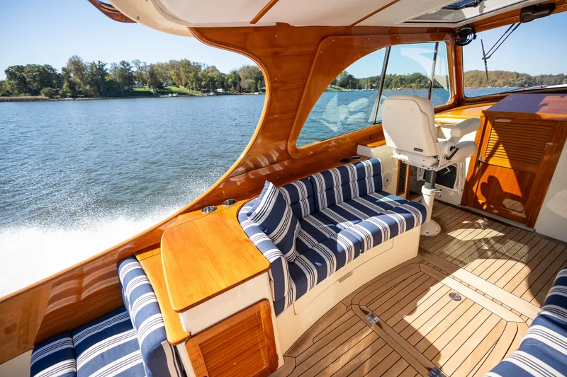 Slide: The Image of Luxurious interior of 2017 Hinckley Picnic Boat 37 MKIII with striped seating and wooden finishes. - 15