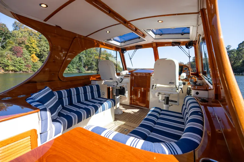 Slide: The Image of Luxurious 2017 Hinckley Picnic Boat 37 MKIII interior with striped seating and polished wood finish. - 17