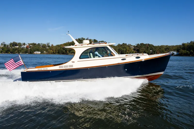 The Image of 2017 Hinckley Picnic Boat 37 MKIII cruising on a sunny day with American flag. - 1