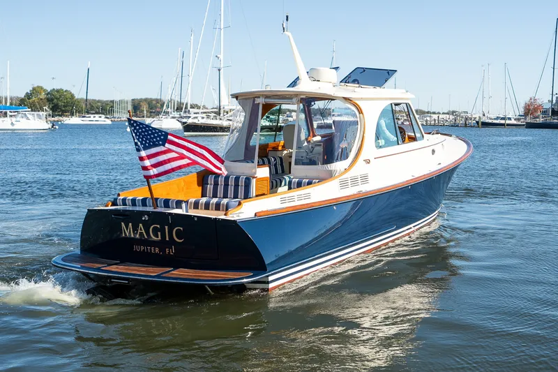 Slide: The Image of 2017 Hinckley Picnic Boat 37 MKIII cruising on water with American flag. - 8