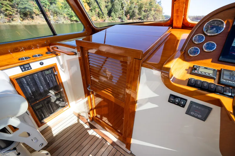 Slide: The Image of 2017 Hinckley Picnic Boat 37 MKIII interior with wooden dashboard and control panel. - 31