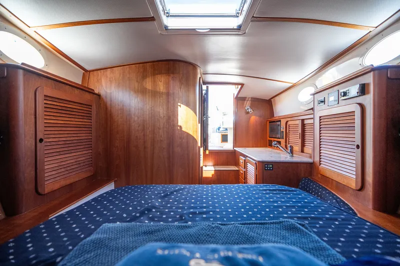Slide: The Image of Interior of 2017 Hinckley Picnic Boat 37 MKIII with wood paneling and cozy cabin layout. - 40