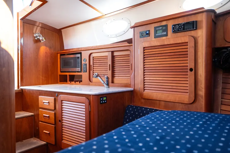 Slide: The Image of Interior of 2017 Hinckley Picnic Boat 37 MKIII with wooden cabinetry and modern amenities. - 39