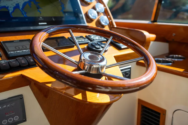 Slide: The Image of Steering wheel of 2017 Hinckley Picnic Boat 37 MKIII with navigation display. - 26