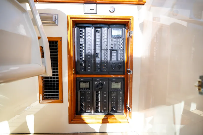 Slide: The Image of Electrical panel inside 2017 Hinckley Picnic Boat 37 MKIII, featuring control switches and displays. - 43