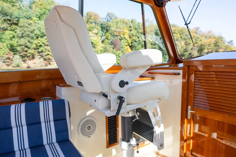 Slide: The Image of Captain's chair in 2017 Hinckley Picnic Boat 37 MKIII, featuring elegant wood interior. - 21
