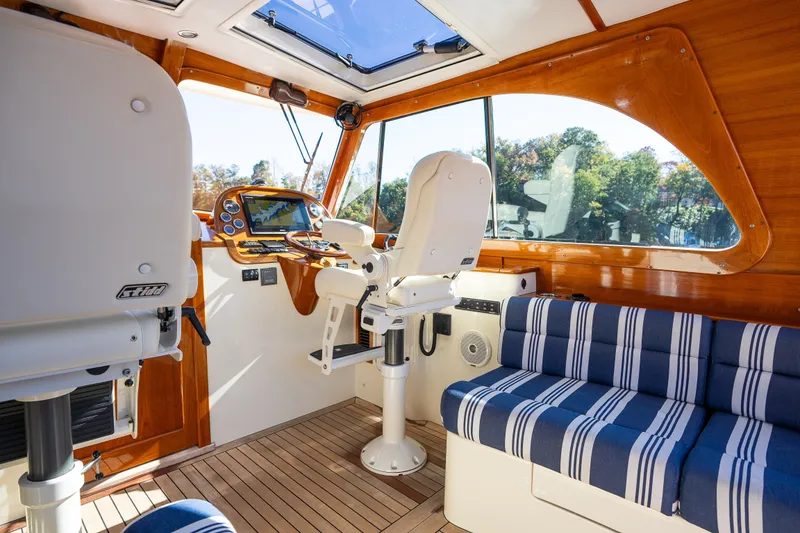 Slide: The Image of Interior of 2017 Hinckley Picnic Boat 37 MKIII with striped seating and navigation controls. - 23