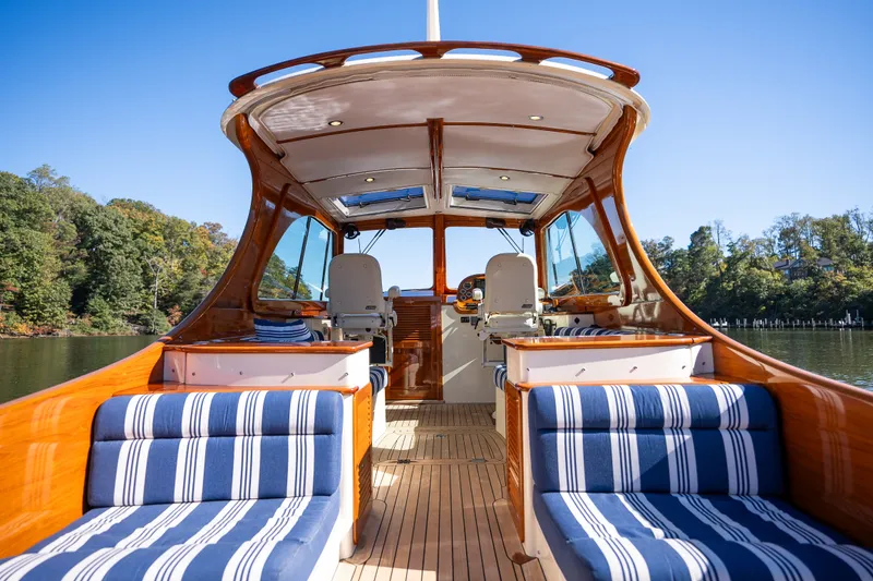 Slide: The Image of 2017 Hinckley Picnic Boat 37 MKIII with striped seating, elegant wood finish, and open cockpit. - 13