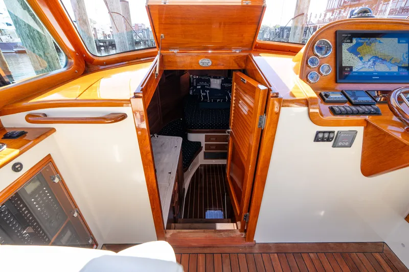 Slide: The Image of 2017 Hinckley Picnic Boat 37 MKIII interior with wood finish and navigation equipment. - 32