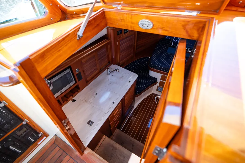 Slide: The Image of Luxurious interior of 2017 Hinckley Picnic Boat 37 MKIII with wood finish and compact kitchen. - 33