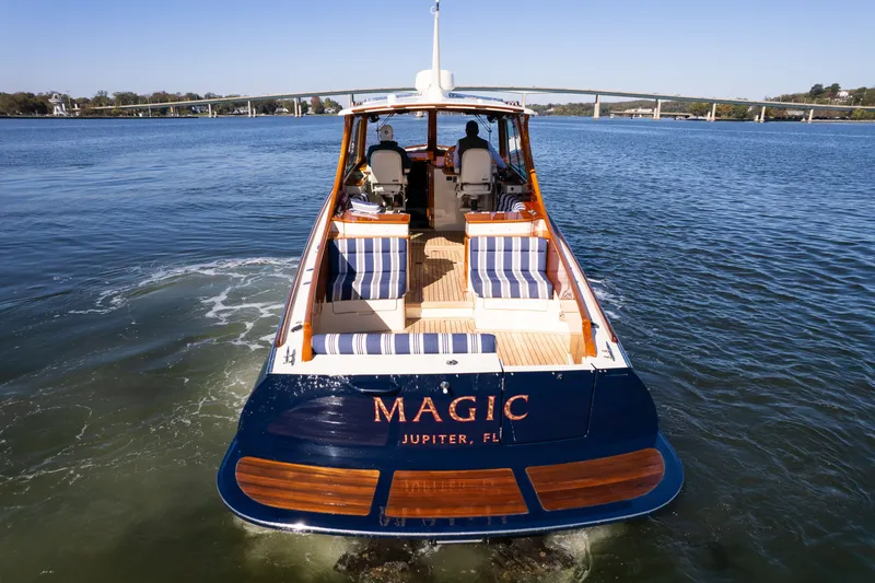 Slide: The Image of 2017 Hinckley Picnic Boat 37 MKIII cruising on calm waters, rear view. - 9
