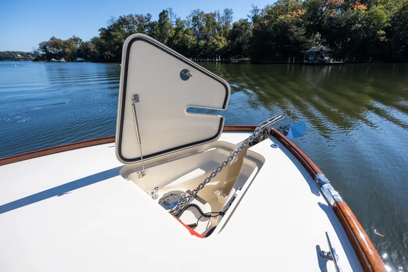 Slide: The Image of 2017 Hinckley Picnic Boat 37 MKIII anchor compartment open on calm water. - 49