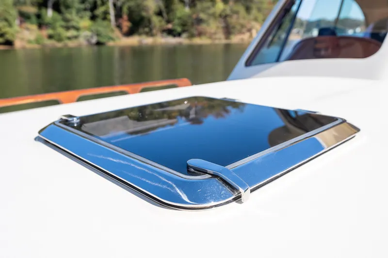 Slide: The Image of Close-up of a 2017 Hinckley Picnic Boat 37 MKIII hatch with reflective surface. - 48