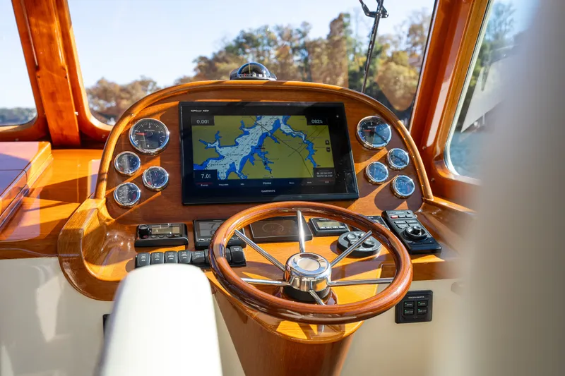 Slide: The Image of Hinckley Picnic Boat 37 MKIII 2017 helm with navigation display and wooden steering wheel. - 25