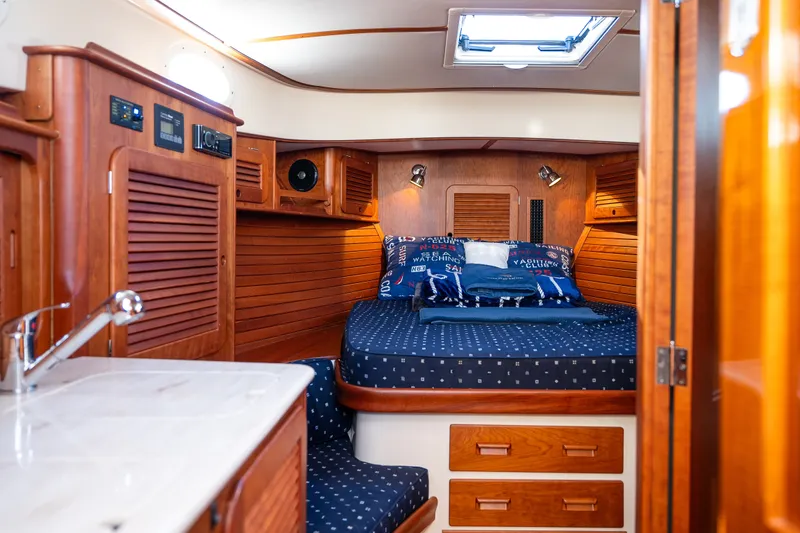 Slide: The Image of Luxurious cabin interior of 2017 Hinckley Picnic Boat 37 MKIII with wood finish and cozy bedding. - 35