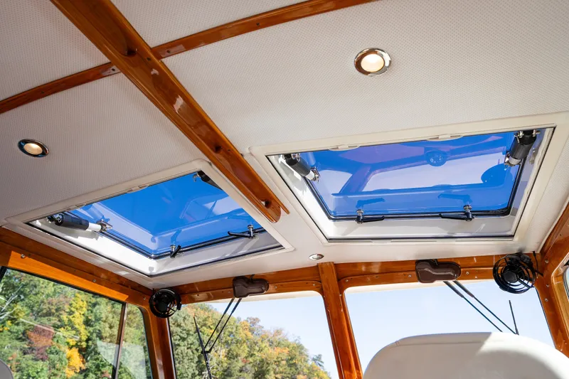 Slide: The Image of Interior view of 2017 Hinckley Picnic Boat 37 MKIII with skylights and wooden trim. - 19