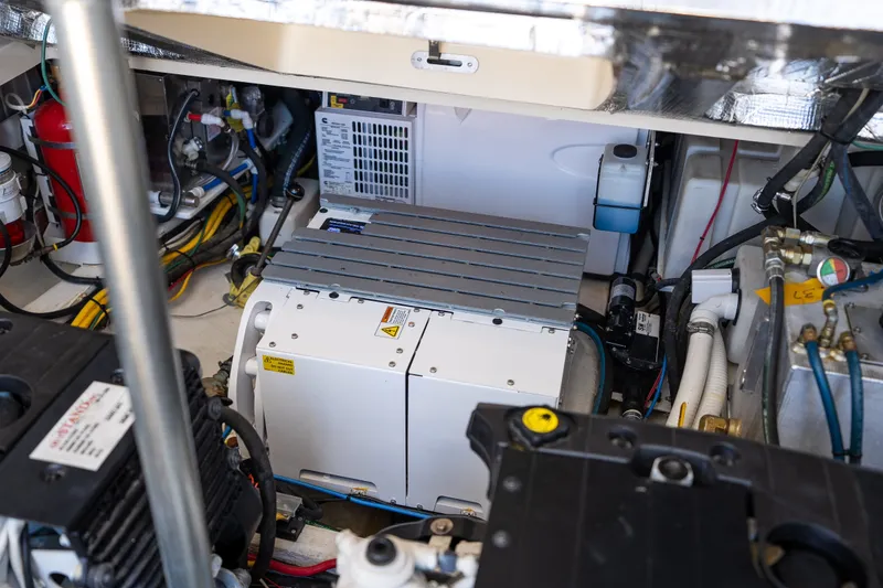 Slide: The Image of Engine room of 2017 Hinckley Picnic Boat 37 MKIII, showcasing mechanical components and wiring. - 46