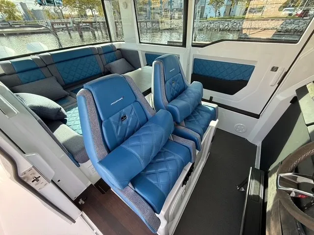 Slide: The Image of Interior of the 2024 Axopar 37 XC Cross Cabin with blue seats and sofa. - 24