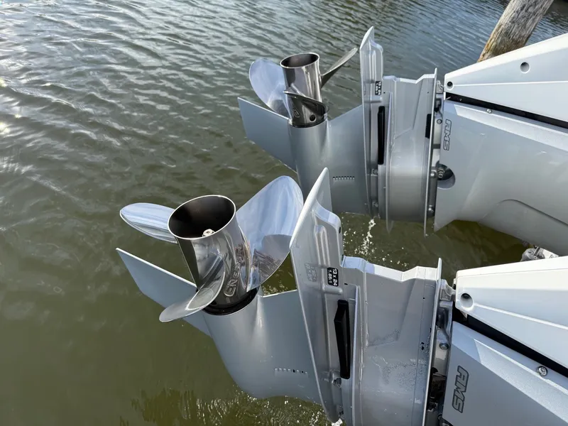 Slide: The Image of Two shiny outboard motors in the water, belonging to an Axopar 37 XC Cross Cabin boat. - 31