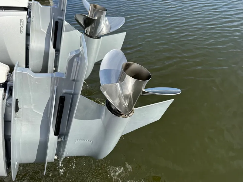 Slide: The Image of Close-up of two outboard motors in the water. - 32