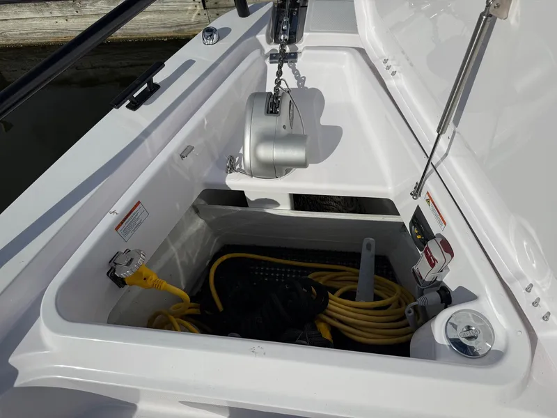 Slide: The Image of An open storage compartment on a boat with yellow cable and anchor winch. - 18