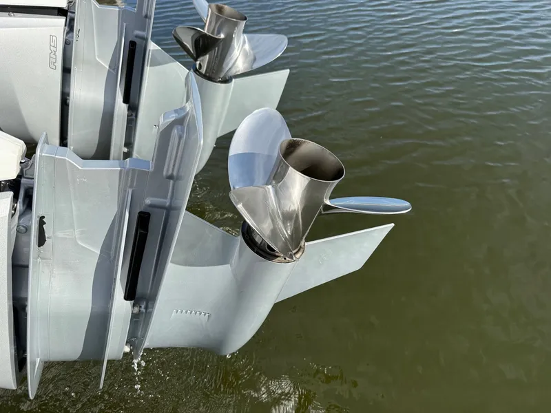 Slide: The Image of Close-up of two outboard motors in the water, featuring shiny propellers. - 33