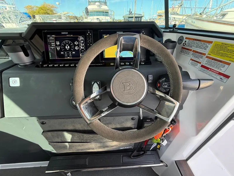 Slide: The Image of The image shows the helm of a 2024 Axopar 37 XC Cross Cabin with modern instruments. - 30