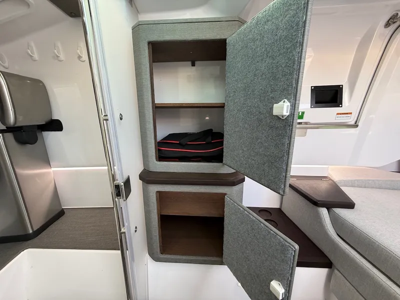 Slide: The Image of Interior of an Axopar 37 XC Cross Cabin with gray cabinets and a seating area. - 22