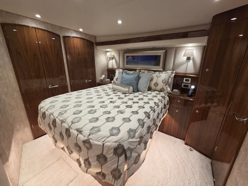 Slide: The Image of Luxurious bedroom with a large bed, wooden cabinetry, and soft lighting. - 19