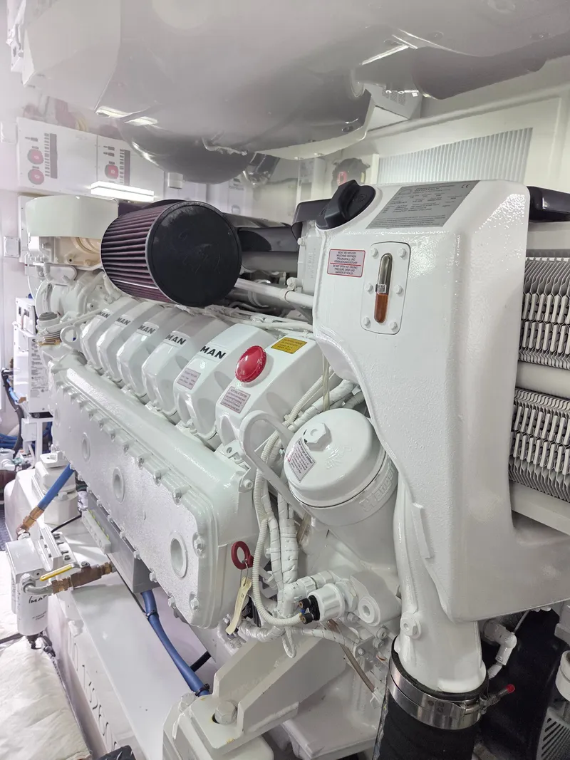 Slide: The Image of A powerful engine in a clean engine room of a 2023 Viking Convertible boat. - 29