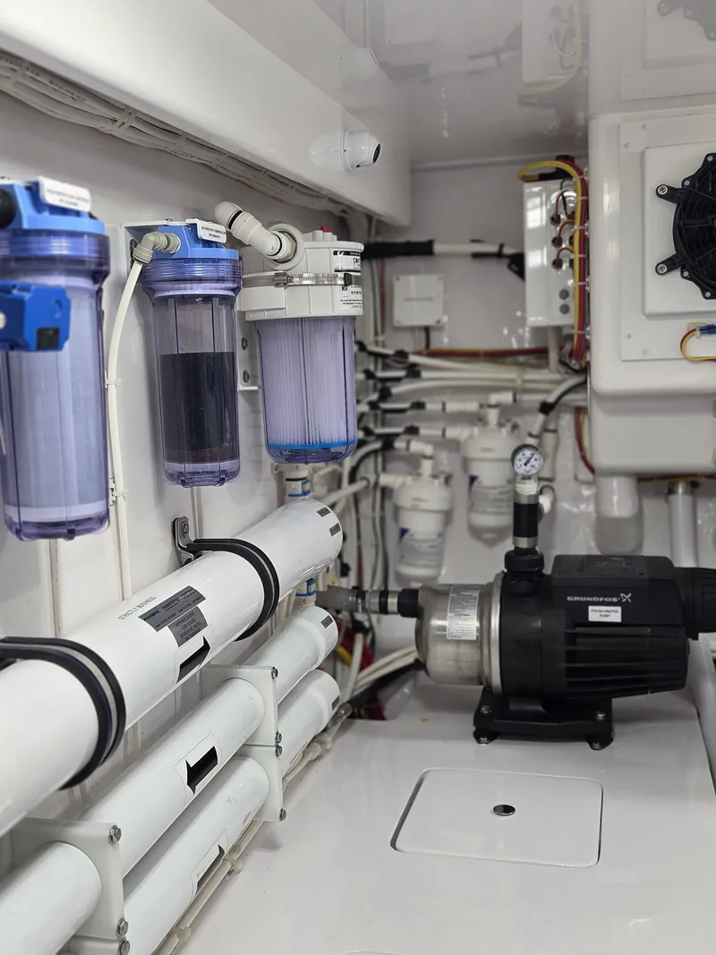 Slide: The Image of Engine room of the 2023 Viking Convertible with filters and pumps. - 32