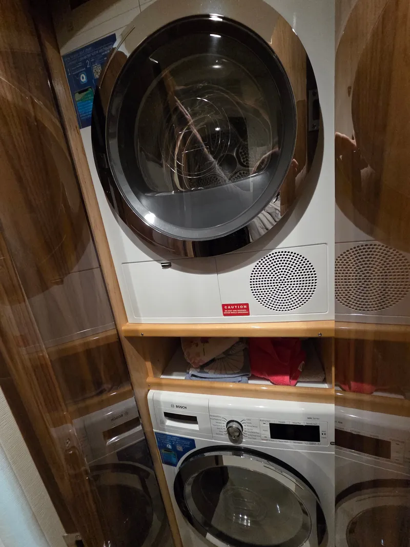 Slide: The Image of The laundry area on the 2023 Viking Convertible features modern washers and dryers. - 26