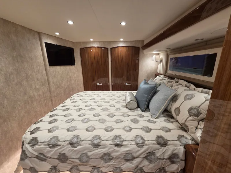 Slide: The Image of Luxurious bedroom with king-size bed, elegant bedding, wooden doors, and a flat-screen TV on the wall. - 21
