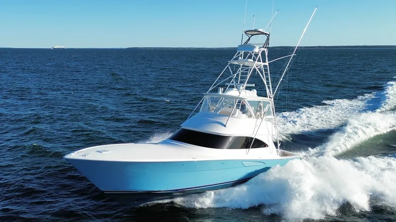 The Image of 2023 Viking Convertible on open sea, featuring a blue hull and distinctive tower. - 1