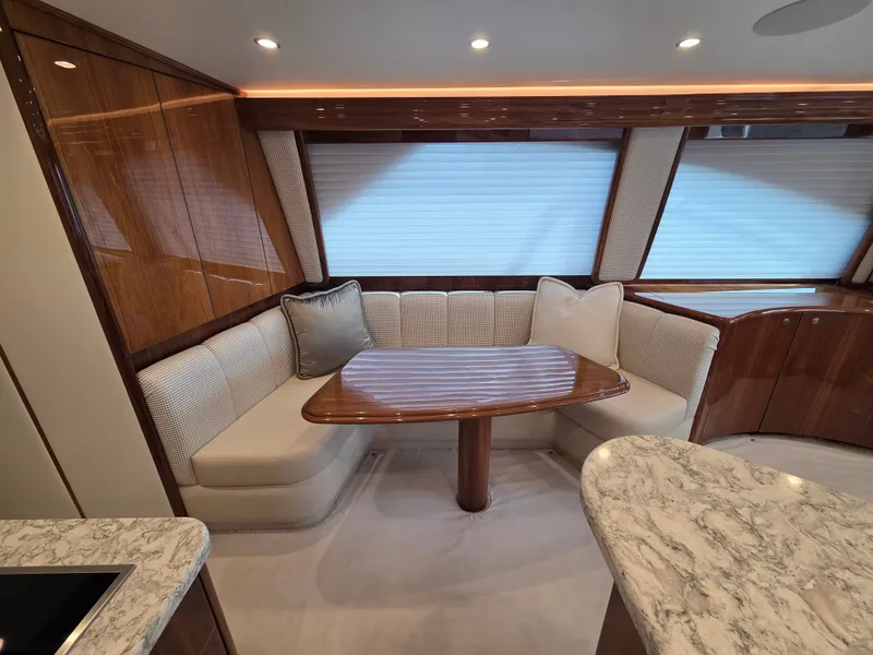 Slide: The Image of Elegant dining area with a wooden table and cushioned benches in a modern yacht. - 17