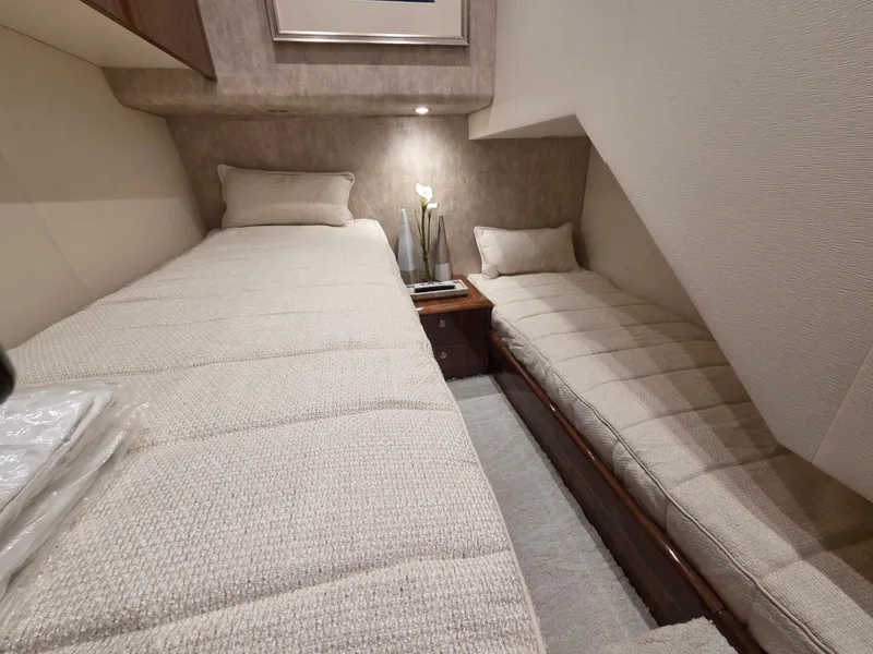 Slide: The Image of Interior of the 2023 Viking Convertible with two single beds and a nightstand. - 24