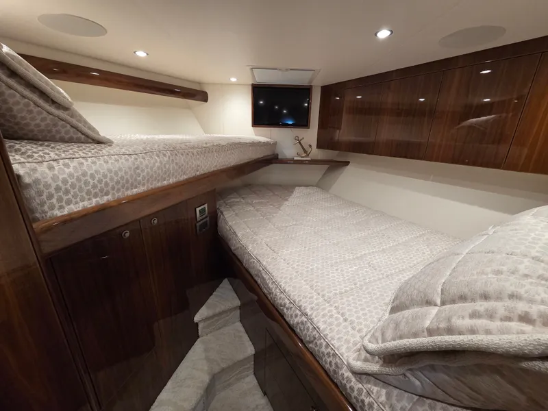 Slide: The Image of Interior of a modern cabin with two beds and wooden furnishings. - 23